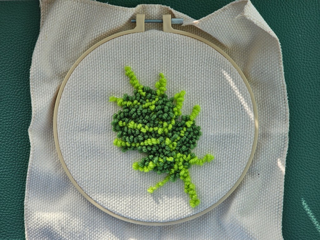 Partially finished punch needle project featuring a monstera leaf