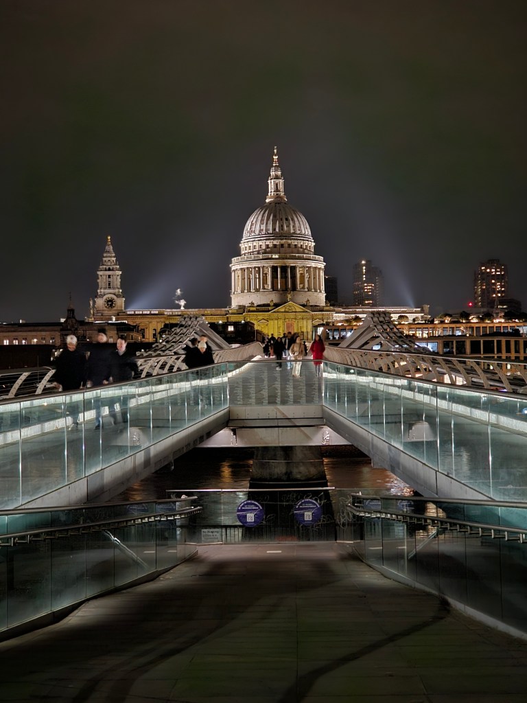 St Paul's Cathedral, London, seen from the end of Millennium Bridge, at night.