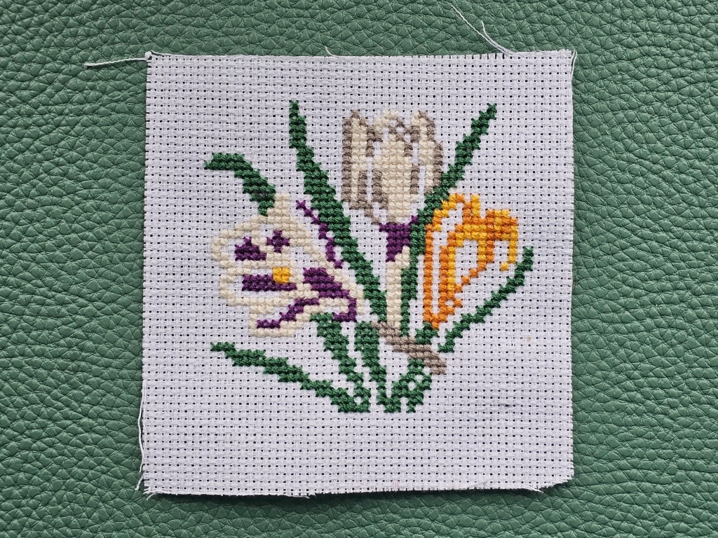 Nearly completed small cross stitched crocuses from an assorted kit