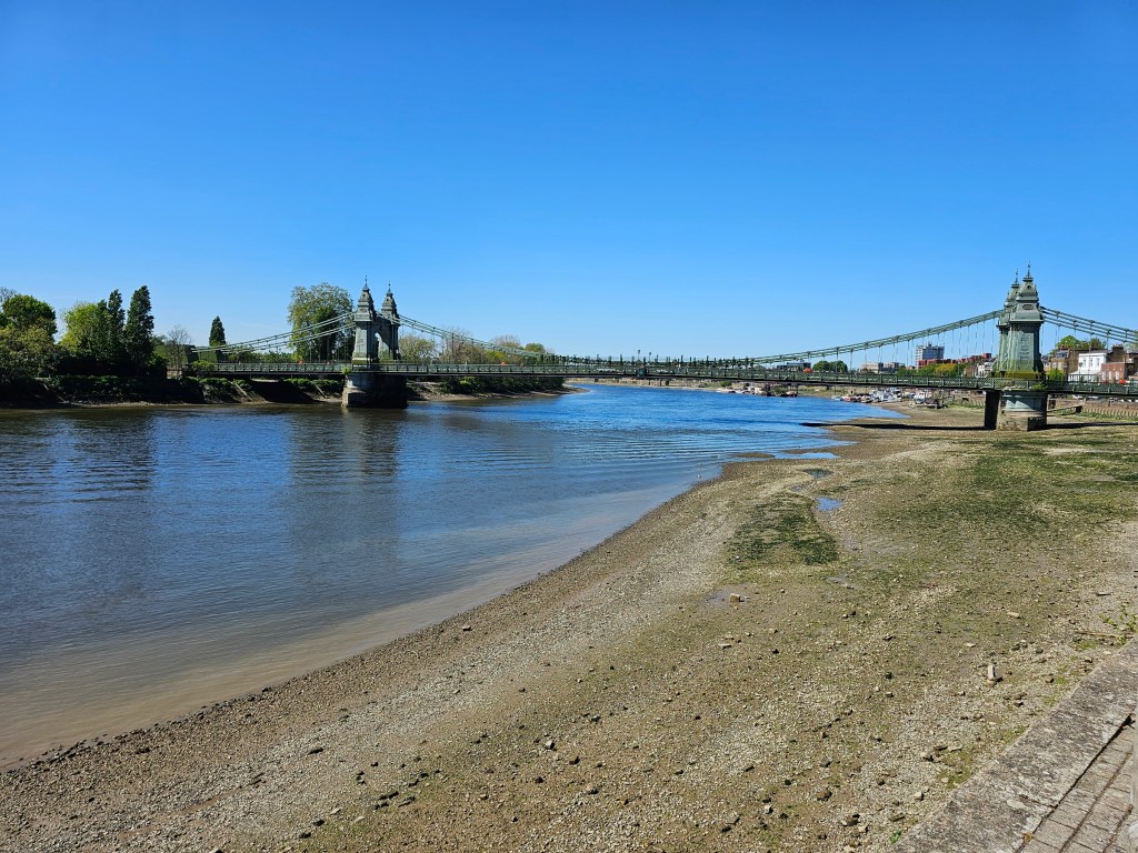 A bridge over the Thames in west London. The water level in the river is really low - there's a gravel beach on the bank of the river