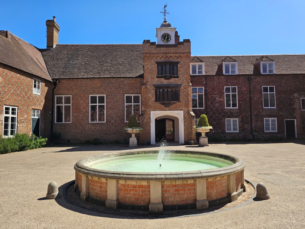 A patio with a small fountain in Fulham Palace, London