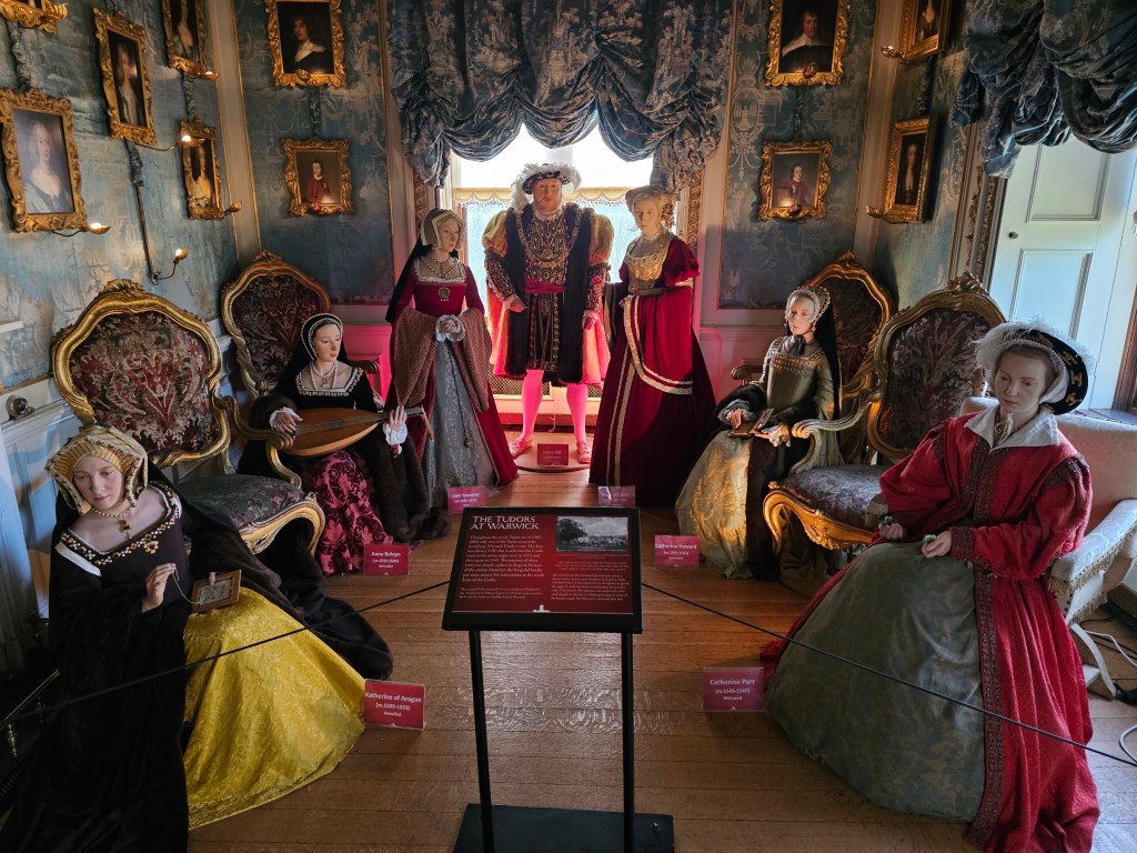 A small room in Warwick Castle, England, with realistic life size figures of Henry VIII and his 6 wives