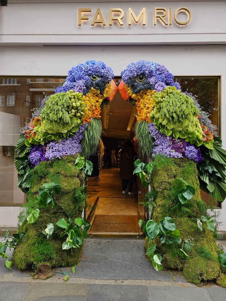Two large, colourful parrots made out of flowers. Photo taken during Chelsea in Bloom event in London in 2026