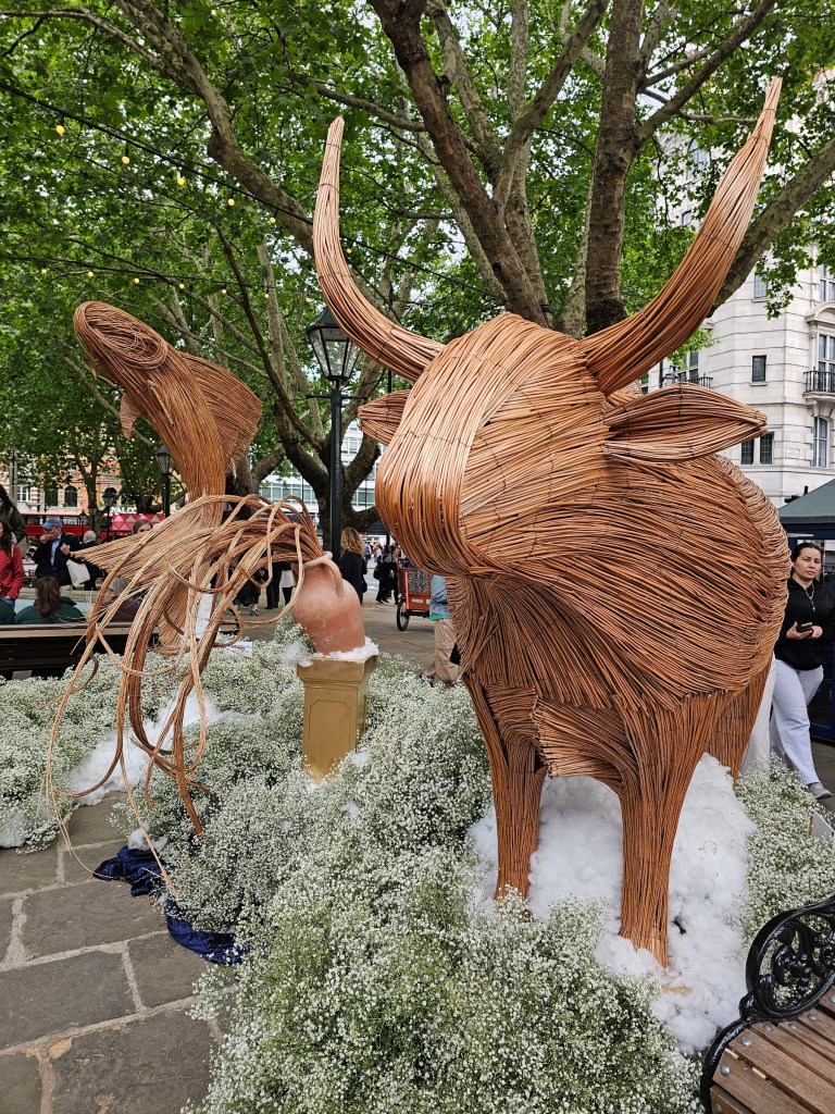 Statues of zodiac signs: taurus, aquarius and pices. Photo taken during Chelsea in Bloom event in London in 2026