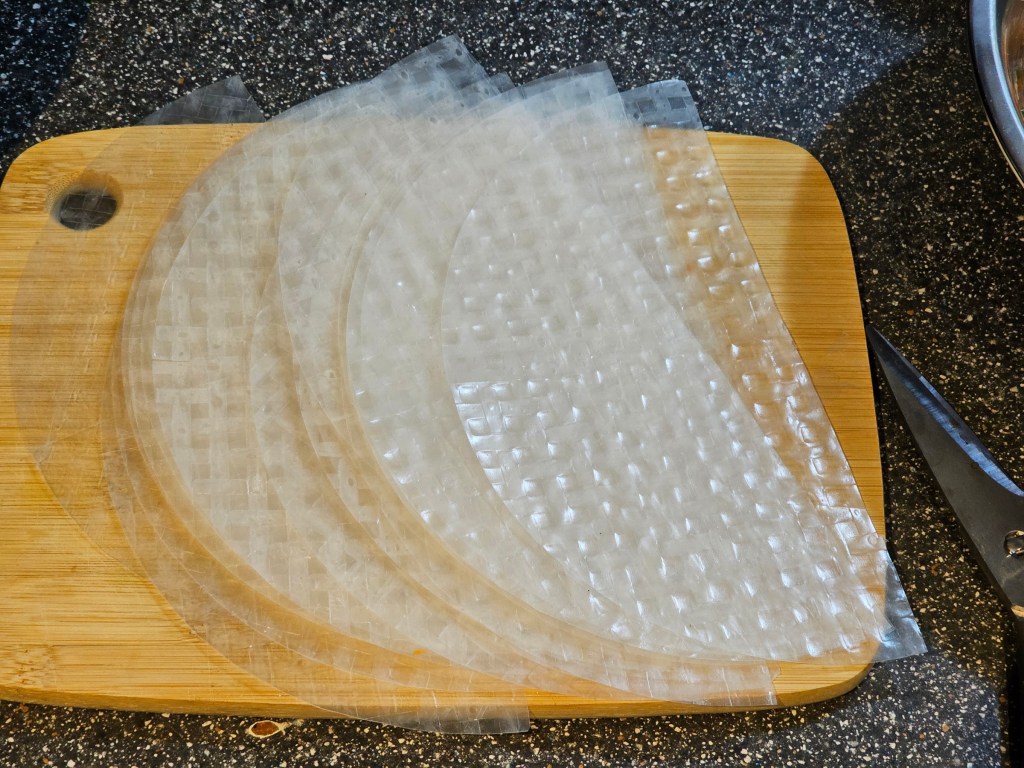A stack of rice paper sheets cut in half