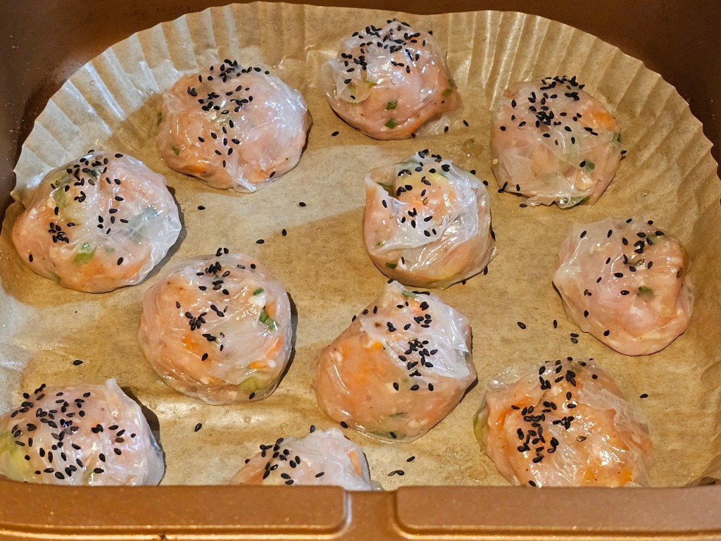 Shaped chicken dumplings placed in an air fryer