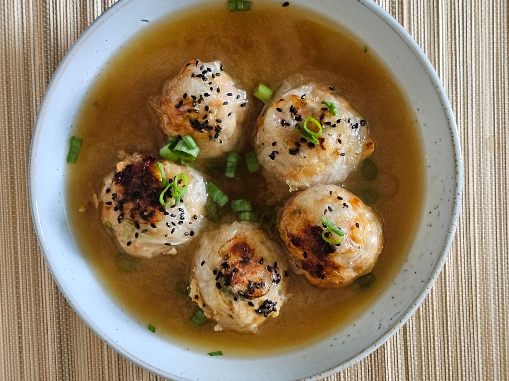 Chicken dumplings in a bowl of miso soup