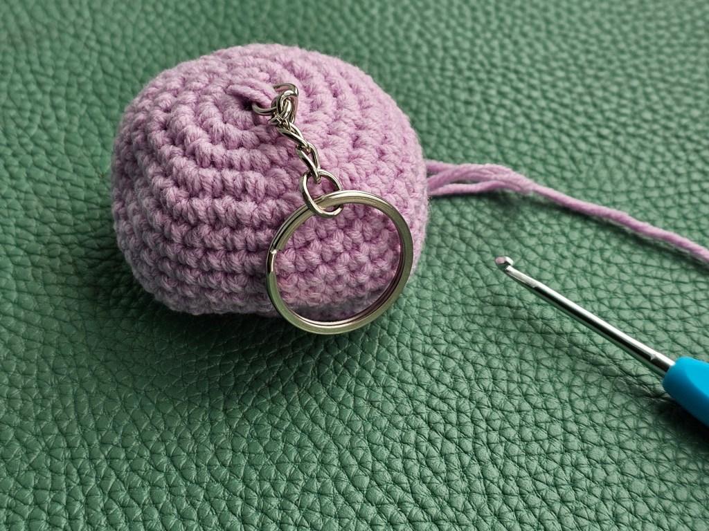 Half-completed crocheted balloon, with a key chain attached