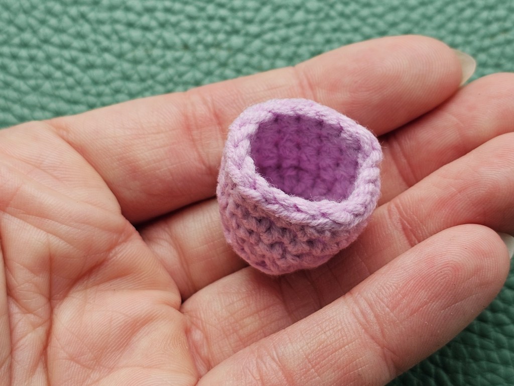 Tiny pink crocheted basket for a hot air balloon