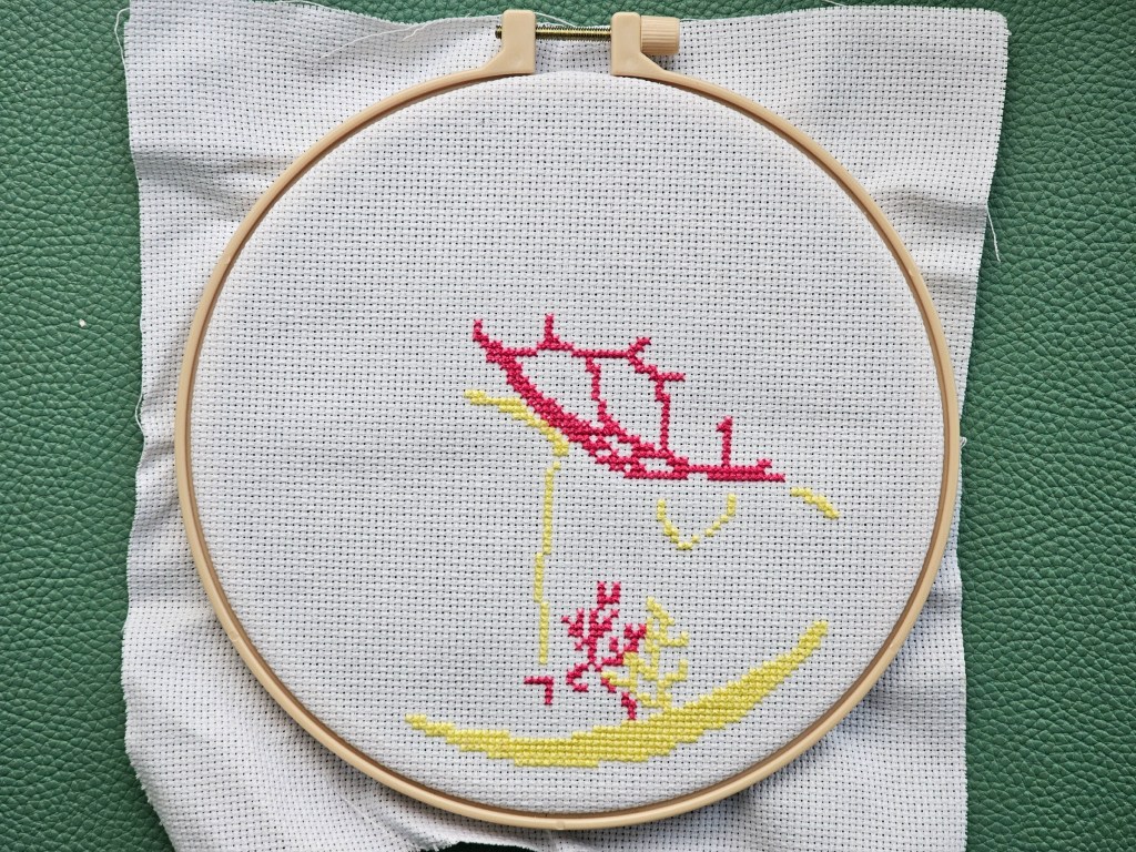 The first two colour blocks for a cross stitch project sew on a white fabric