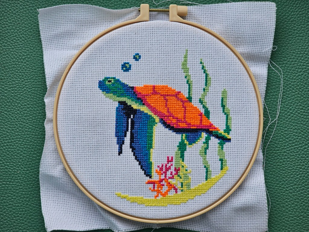 Completed cross stitch design featuring a turtle
