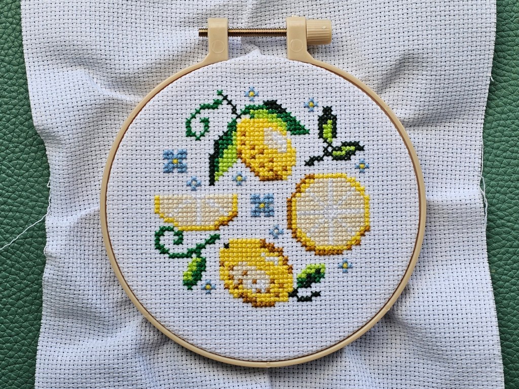 Finished cross stitch project featuring a lemon design