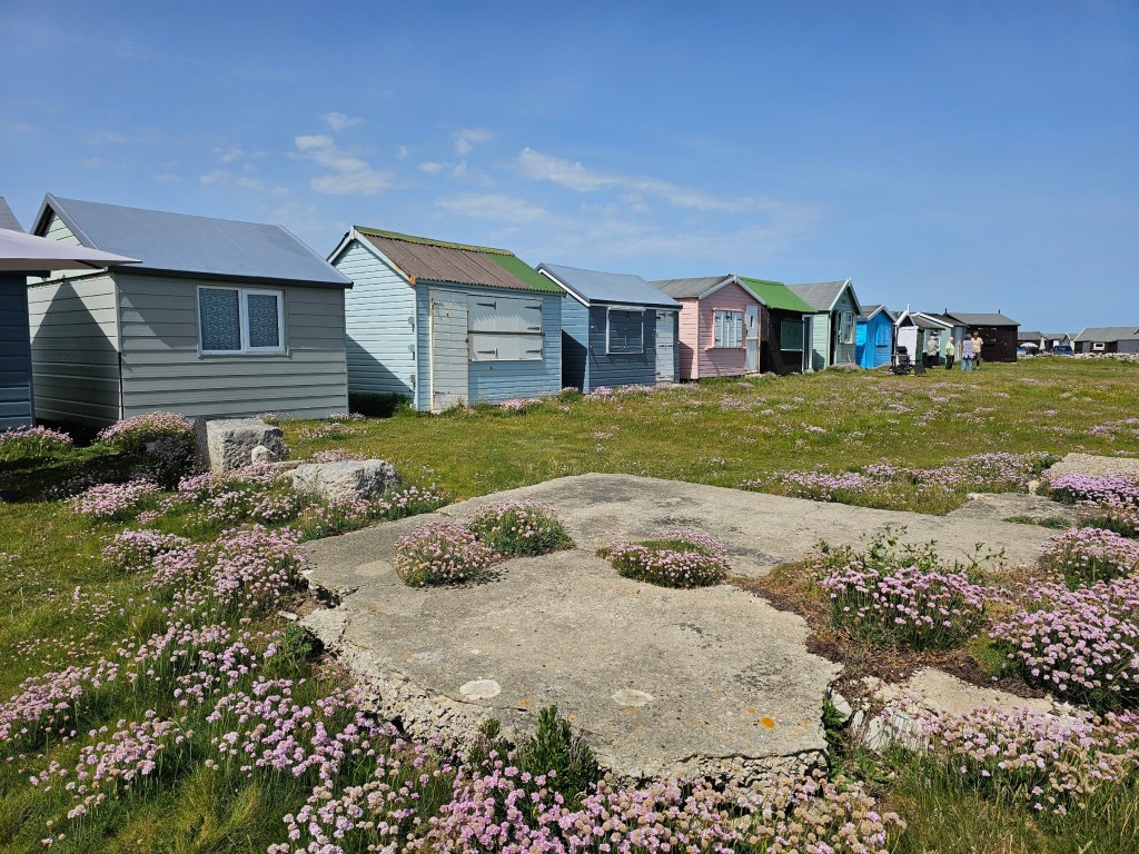 Colourful wooden huts near Portland Bill lighthouse, Isle of Portland, UK
