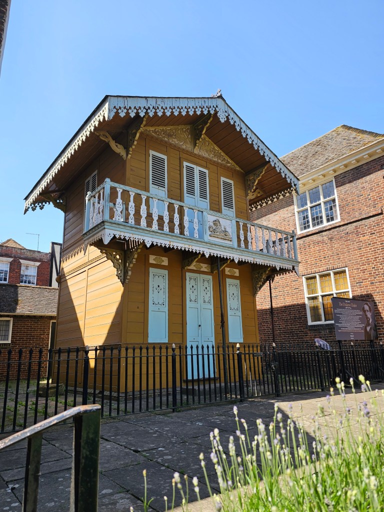 The chalet where Charles Dickens wrote some of his novels - a narrow, two-floor wooden building, painted in mustard yellow