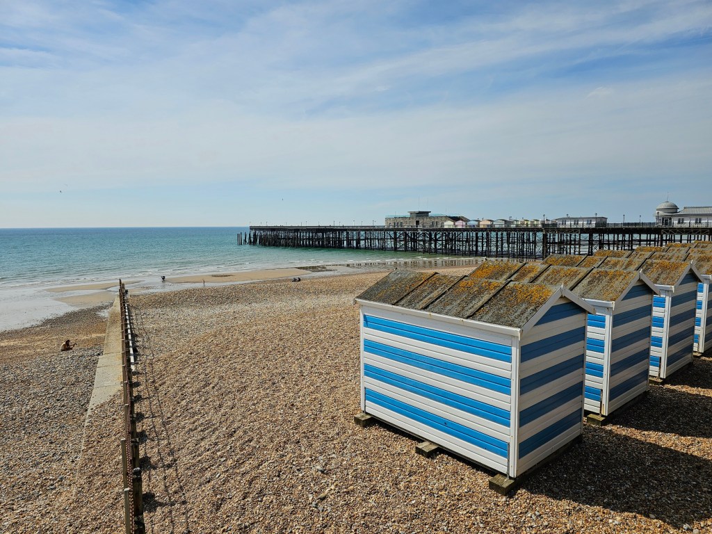 Blue and white striped beach huts in Hastings, England