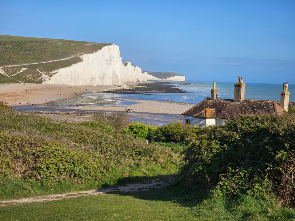 A view of Seven Sisters white cliffs and the iconic huts in England south coast