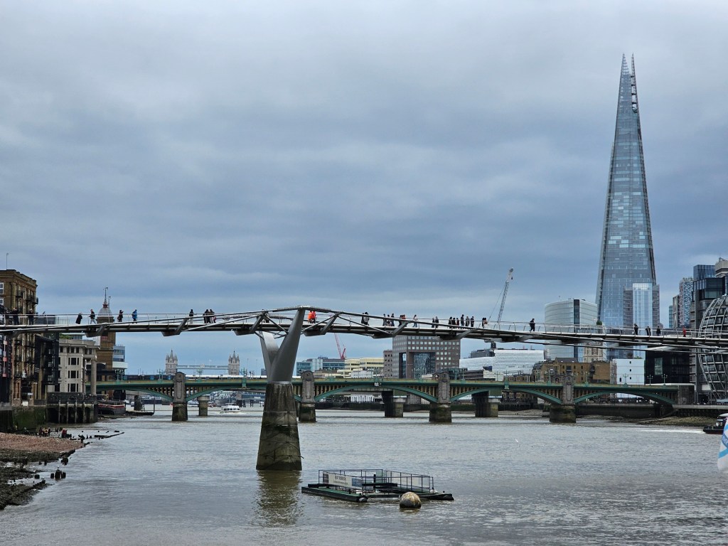 A view of millenium bridge and the shard from the Thames Path, London