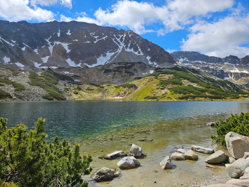 A crystal clear lake surrounded by mountains