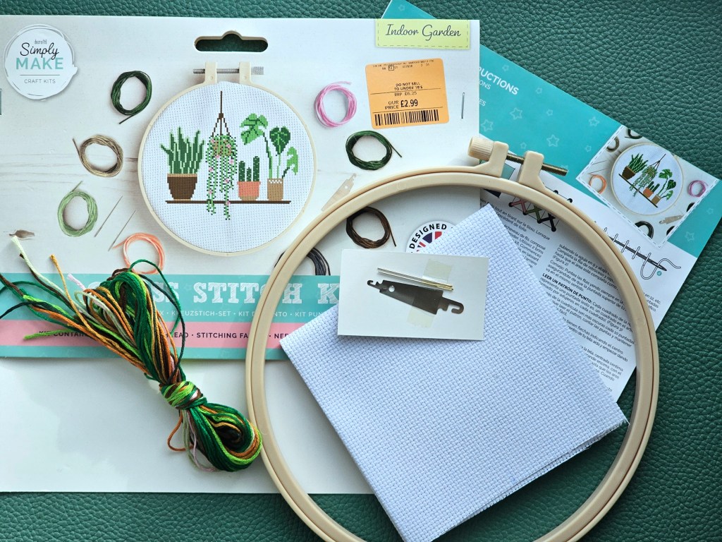 Contents of an assorted cross stitch set with a design featuring house plants