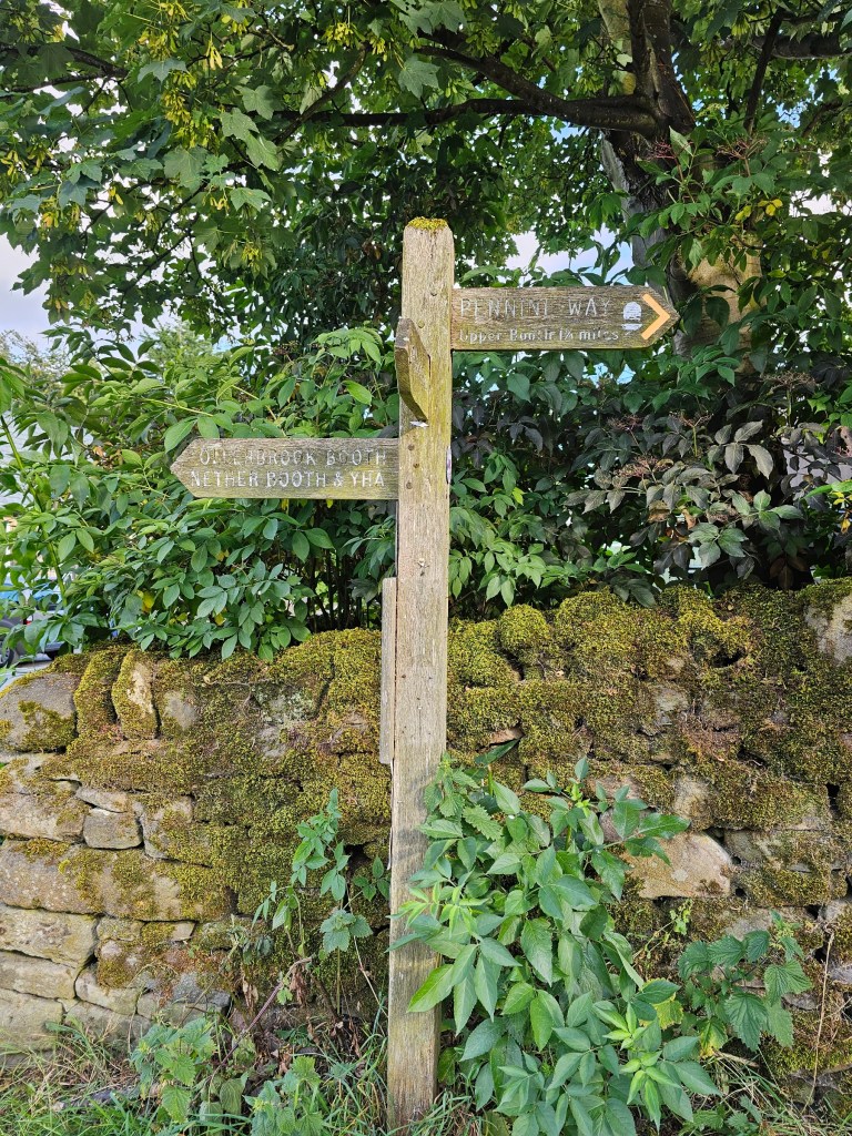 A signpost with trails in Edale, England