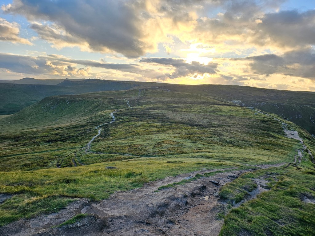 A view of paths running across the hills near Edale in Peak District, England. Photo taken during golden hour.