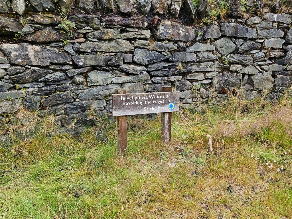Signposts for Helvellyn summit avoiding the edges