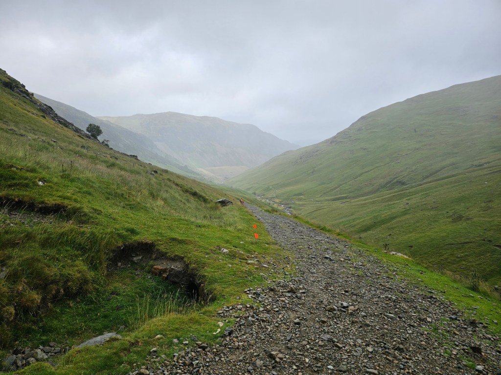 A gravel path on the trail to Helvellyn, in dense fog