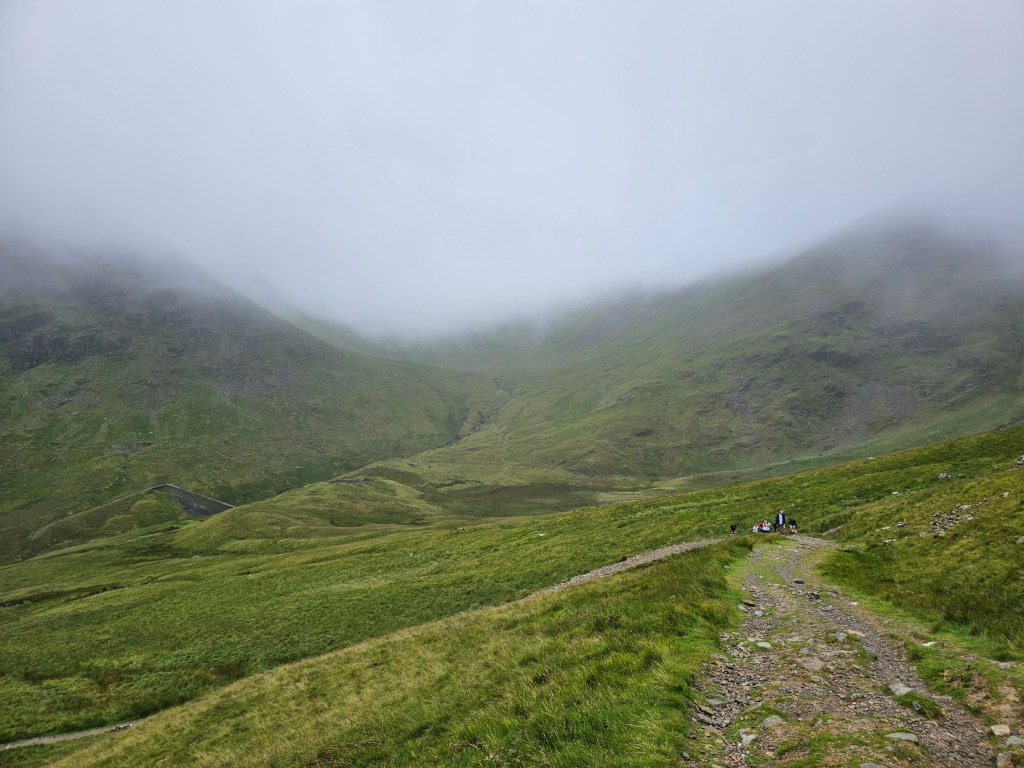A gravel path on the trail to Helvellyn, in dense fog