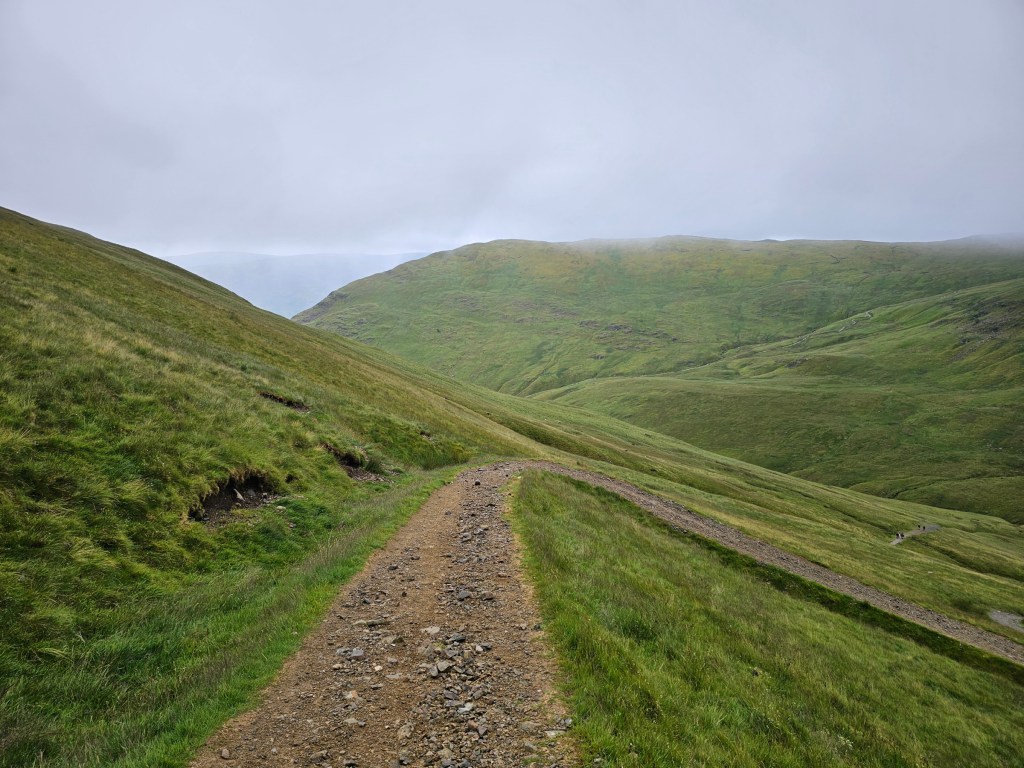 A gravel path on the trail to Helvellyn, in dense fog