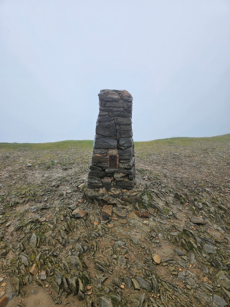 Trig point on top of Helvellyn, Lake District. There's a dense fog and no spectacular views