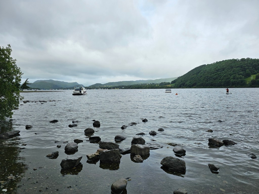 Large stones in the water on the shore of Ullswater lake