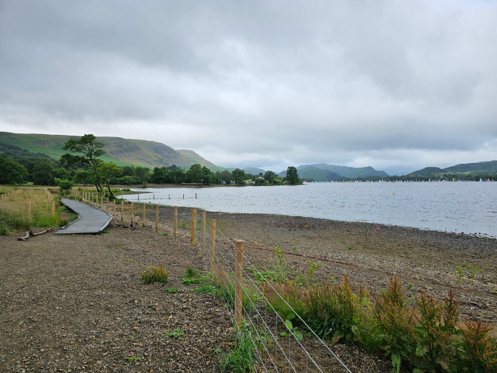 Ullswater lakefront. A gravel shore with some hills in the background