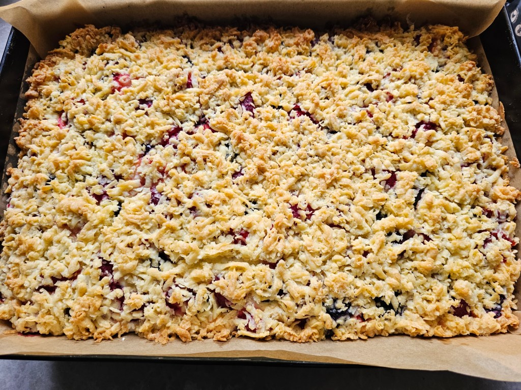 A tray with shortbread cake with a meringue layer and berries