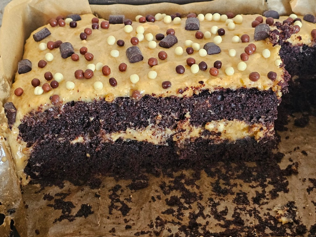 A tray with egg-free salted peanut butter chocolate cake, half eaten