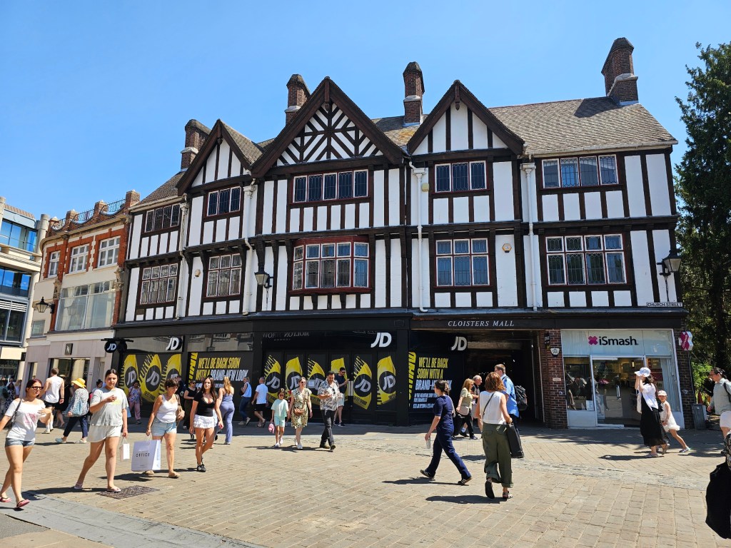 Old, characteristic white and brown building in Kingston, London - now home to some shops