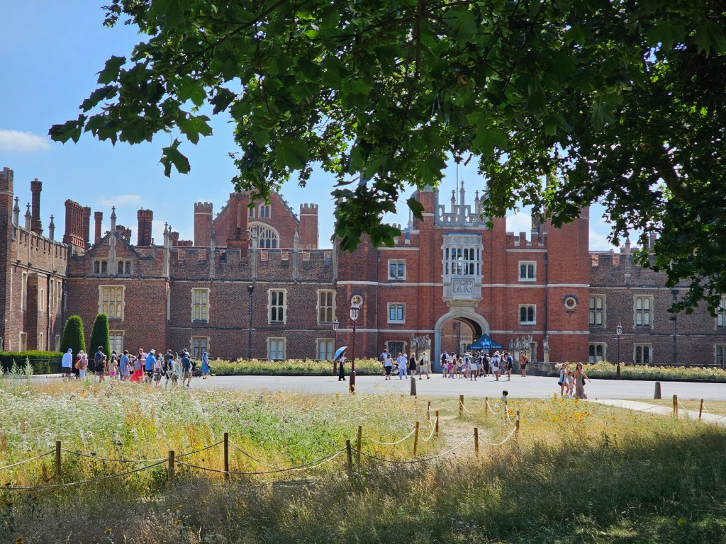 Crowds at the entrance to Hampton Court Palace, London