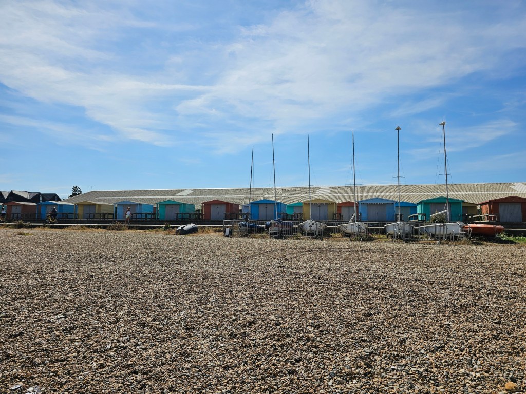 Colourful beach huts by the sea near Whitstable, seen from the beach