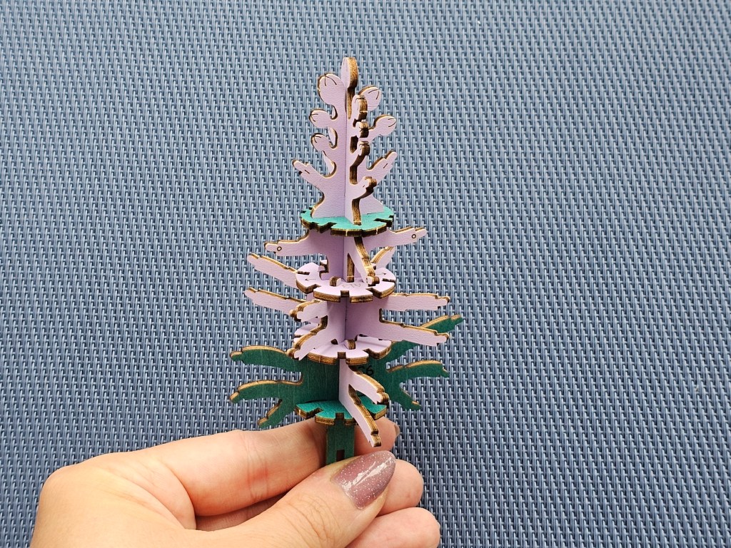 Assembling a wooden lilac flower. The wooden core will be the base for the flowers.