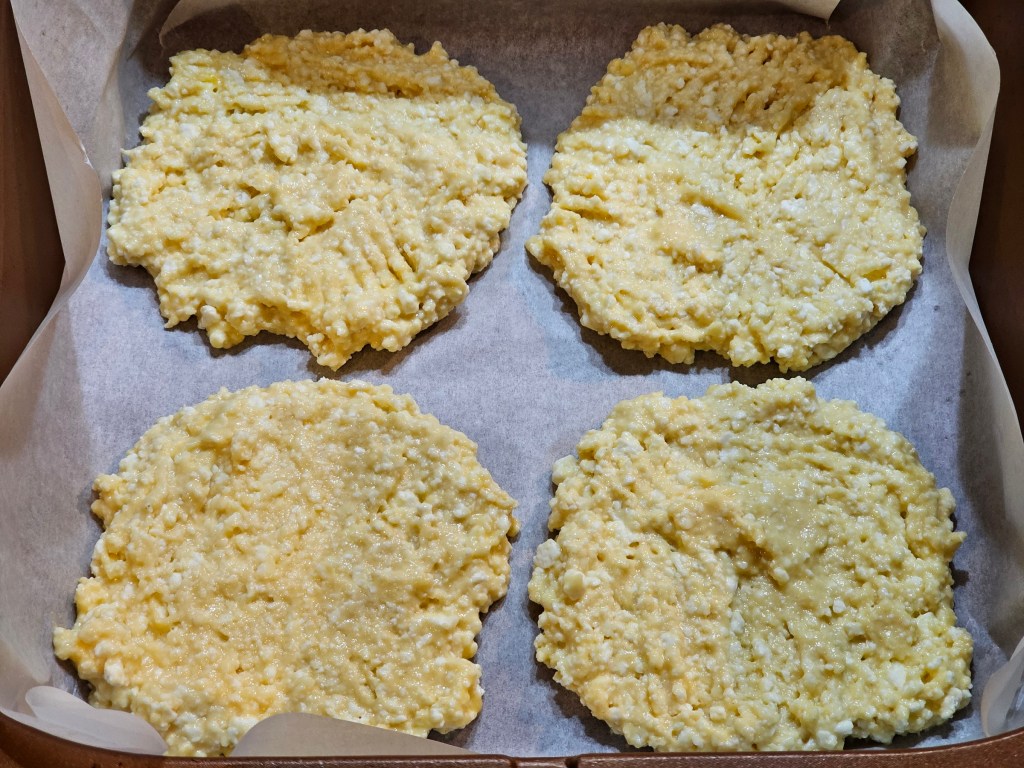 4 circles made of high protein batter for plum pastries.