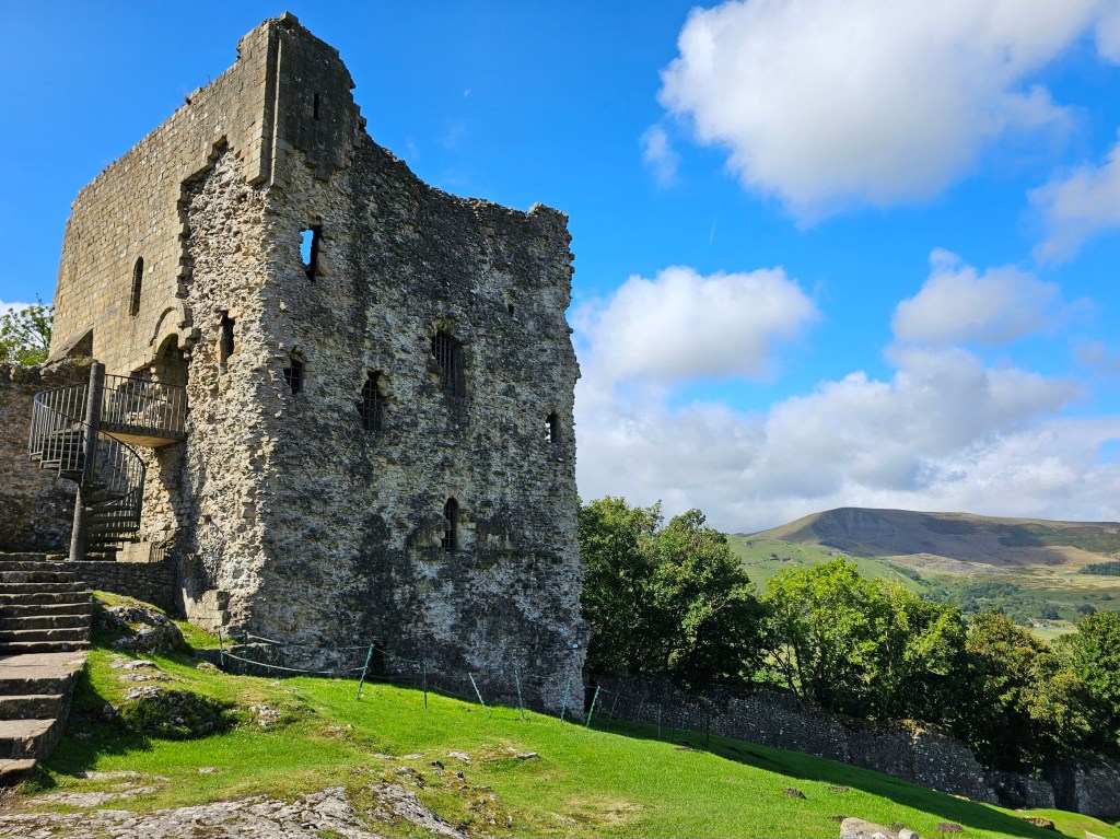 Ruins of Castleton Castle. Mam Tor can be seen in the background.